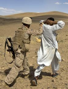 A U.S. soldier detains an Afghan man in Farah Province