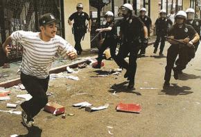 Police chase a a young man during 1992 riots in Los Angeles