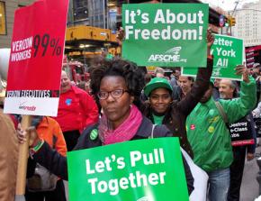 Occupy Wall Street supporters march in solidarity with Verizon workers