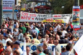 Greek workers march in Athens during the one-day strike on October 5