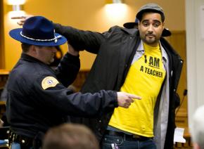 Jesse Hagopian escorted from a state legislature hearing after attempting a citizen's arrest of lawmakers