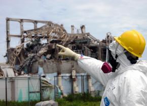 An IAEA inspector surveys damage at the Fukushima plant's Reactor Unit 3