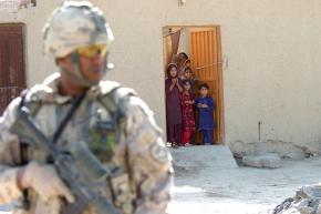 U.S. soldiers pass through a village on the outskirts of Kandahar City
