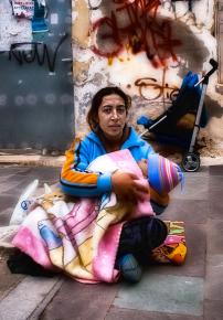 A single mother and her child survive on the streets of Athens