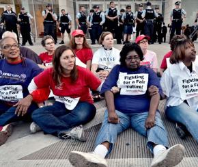 SEIU members sit in with Chicago teachers at a protest last fall