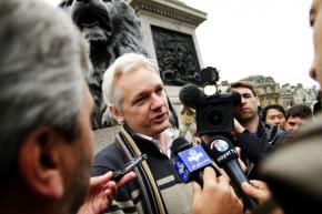 Julian Assange speaking with reporters at an antiwar demonstration in Trafalgar Square