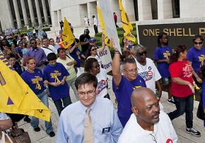 Houston janitors and their supporters march in front of One Shell Plaza