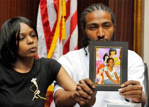 Aiyana Jones' parents hold up her picture at a press conference