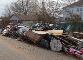 Debris piled outside storm-damaged homes on Staten Island