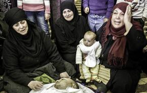 A family living near Homs mourns a loved one killed in the bombing