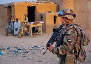 A French soldier patrols a small village in Mali