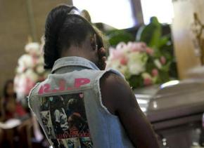 A fellow student mourns at the funeral of a Harper High School student killed by gun violence