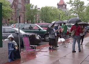Picketing in the rain against the removal of downtown benches in Northampton, Mass.