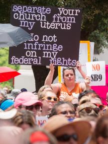 Abortion rights activists crowd around the Texas state Capitol building