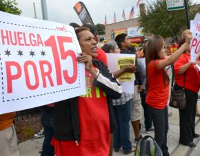 Fight for 15 strikers rally with supporters outside a Subway