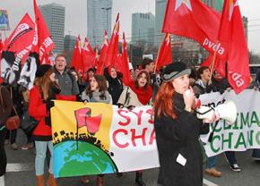 Protesters march for system change outside the Warsaw climate conference