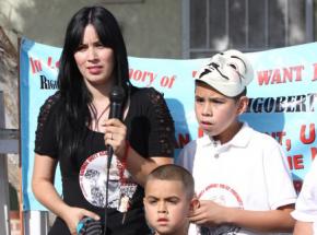 Christopher Arceo (right) stands with his mother and brother at a protest demanding justice for his father