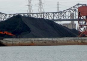 Petcoke piles loom over the banks of the Calumet River in Southeast Chicago