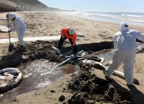 Clean-up workers contain an oil pipeline spill near Ventura, Calif.