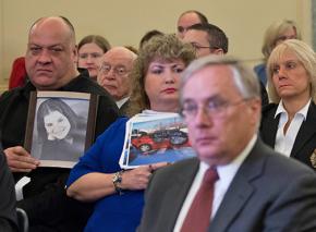 Families of car crash victims sit behind GM executives at a Congressional hearing on the recall delay