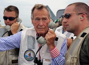 George H.W. Bush participates in a photo op aboard an aircraft carrier named after him