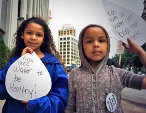 Kids join in a protest against the planned shutoff of water services