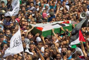 Mourners march in a funeral procession for a Palestinian killed in Israel's air strikes