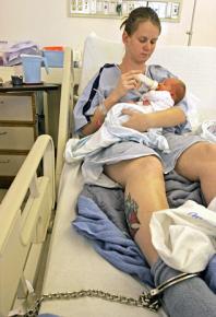 An incarcerated women holds her infant