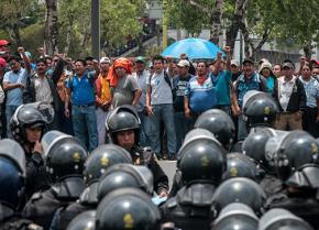 Oaxaca teachers organized in the CNTE face off with police at a mass march