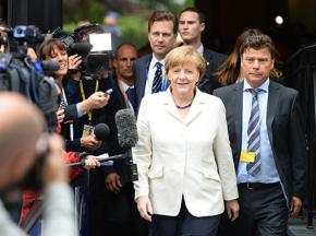 German Chancellor Angela Merkel surrounded by the media