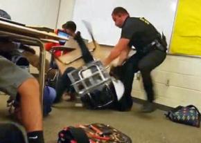 An armed police officer assaults a child in a South Carolina classroom