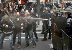 French riot police pepper spray press and protesters outside the UN climate summit