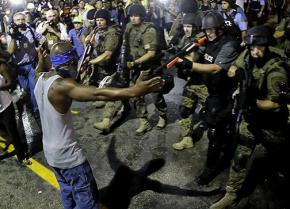 Police train their weapons on a protester in Ferguson, Missouri