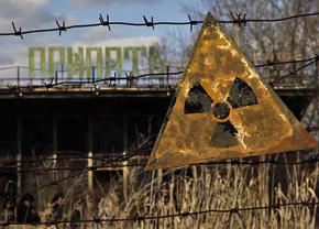 A radioactive sign hangs on barbed wire outside a café in Pripyat