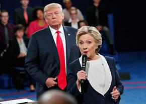 Donald Trump lurks behind Hillary Clinton during the second presidential debate