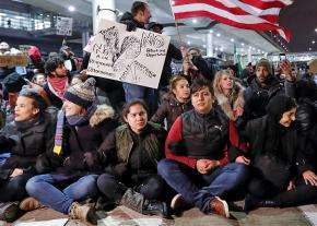 Opponents of Trump's ban at an airport sit-down
