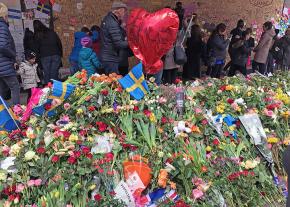 Mourners lay flowers to honor the victims of a terrorist attack in Stockholm