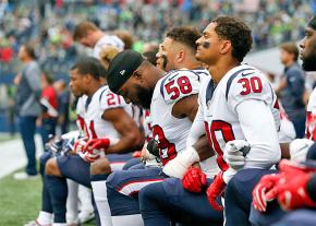 Members of the Houston Texans kneel in protest during the national anthem