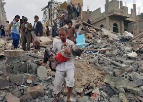 Civilians rescue a child from the rubble after a coalition air strike in Sana'a