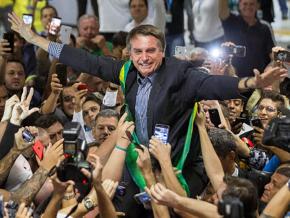Far-right presidential candidate Jair Bolsonaro greets supporters in Curitiba, Brazil