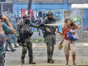 A riot cop in Puerto Rico assaults a May Day protester