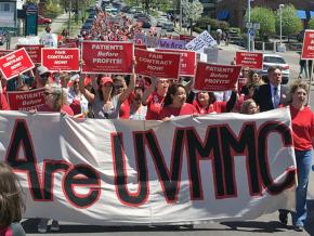 UVM nurses and their supporters march through the streets of Burlington